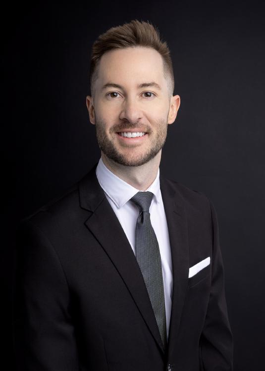 Dr. Ogley in black suit